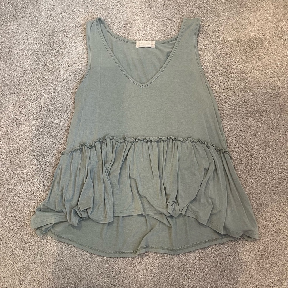 Light green flowwy v-neck tank top with coil and ruffle detail. Size S